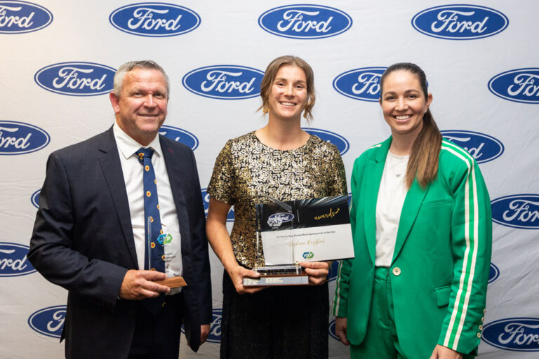 Steph Dryfhout holding her NZ Rural Sportswoman of the Year Award standing with two other people